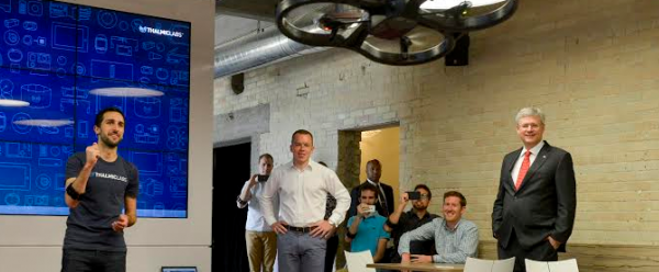 Scott Greenberg, Head of Developer Relations at Thalmic Labs, and Stephen Lake, CEO and co-founder of Thalmic Labs, showcase the Myo armband flying a Parrot drone to Prime Minister Stephen Harper. (left to right)